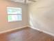 Well-lit bedroom with hardwood floors and a large window showcasing the view at 725 Laurel Way, Casselberry, FL 32707