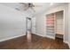 Bedroom with wood floors, ceiling fan and closet with shelving; a comfortable and functional space at 725 Laurel Way, Casselberry, FL 32707