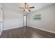 This bedroom includes wood-look floors, ceiling fan, closet, and a large window at 725 Laurel Way, Casselberry, FL 32707