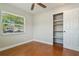 Bright bedroom with wood-look flooring, closet, and natural light at 725 Laurel Way, Casselberry, FL 32707