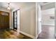 Welcoming entryway featuring wood flooring, a decorative front door, and a sliding door to another room at 725 Laurel Way, Casselberry, FL 32707