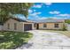 Lovely ranch style home featuring an attached garage and large driveway at 725 Laurel Way, Casselberry, FL 32707