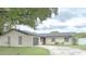 Charming single-story home with a well-maintained lawn and a circular driveway at 725 Laurel Way, Casselberry, FL 32707