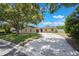 Charming single-story home features a circular driveway, lush landscaping, and mature trees for added curb appeal at 725 Laurel Way, Casselberry, FL 32707
