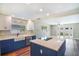 Well-lit kitchen with modern appliances, white cabinets, a farmhouse sink, and a center island at 725 Laurel Way, Casselberry, FL 32707