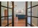 View of the kitchen through french doors, featuring a kitchen island and modern finishes at 725 Laurel Way, Casselberry, FL 32707