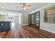 Spacious living room with wood floors, double glass doors, and neutral wall colors, ideal for entertaining at 725 Laurel Way, Casselberry, FL 32707