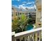 Aerial community view of complex with pool, tropical landscaping, and yellow building at 860 N Orange Ave # 460, Orlando, FL 32801