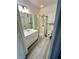 Cozy bathroom featuring a shower, vanity sink, and sleek tile flooring at 860 N Orange Ave # 460, Orlando, FL 32801
