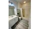 Clean bathroom with sleek tile floors, a vanity sink, medicine cabinet, and a shower-tub combination at 860 N Orange Ave # 460, Orlando, FL 32801