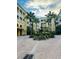 Inviting courtyard view featuring a fountain, landscaped greenery, swaying palm trees, and surrounding buildings at 860 N Orange Ave # 460, Orlando, FL 32801