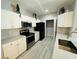 Bright kitchen featuring white cabinetry, granite counters, stainless appliances, and stylish tile flooring at 860 N Orange Ave # 460, Orlando, FL 32801