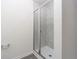 Modern tiled shower with glass doors in a neutral-toned bathroom at 914 Poppy Ln, Dundee, FL 33838