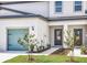Charming townhome with a light blue garage door, manicured lawn and welcoming entrance at 914 Poppy Ln, Dundee, FL 33838