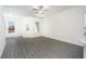 Open floorplan featuring a ceiling fan, neutral paint, and stylish gray wood-look floors at 914 Poppy Ln, Dundee, FL 33838