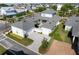 Aerial view of a stylish home with a large patio and multiple garages in a residential area at 921 Bradenville Ln, Winter Garden, FL 34787