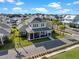 Aerial view of a beautiful two story home with blue sky, palm trees, and a large front porch at 921 Bradenville Ln, Winter Garden, FL 34787