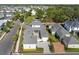 Aerial view highlighting a property with a paved driveway and landscaped yard, surrounded by well-maintained homes at 921 Bradenville Ln, Winter Garden, FL 34787