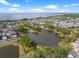 Scenic aerial view of the community with a lake, pier, and the ocean in the background, showcasing its beautiful setting at 921 Bradenville Ln, Winter Garden, FL 34787
