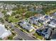 Aerial view of a home with nearby park and pond with green space, mature trees, and sidewalks at 921 Bradenville Ln, Winter Garden, FL 34787