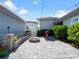 Beautiful backyard featuring a stone fire pit, seating area, and string lights for cozy outdoor gatherings at 921 Bradenville Ln, Winter Garden, FL 34787