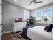 A bright bedroom offering natural light, and features a dresser with television and decorative plant at 921 Bradenville Ln, Winter Garden, FL 34787