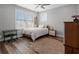 Bedroom with natural light, window, bed, wood floors, and side table at 921 Bradenville Ln, Winter Garden, FL 34787