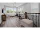 Bright bonus room with ample windows, ceiling fan, vinyl floor and wooden staircase at 921 Bradenville Ln, Winter Garden, FL 34787