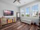 Bonus room featuring a TV, furniture, wood flooring and views of the neighborhood at 921 Bradenville Ln, Winter Garden, FL 34787