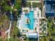 Aerial of community pool: palm trees, lounge chairs, and a wading area create a luxurious and inviting recreation space at 921 Bradenville Ln, Winter Garden, FL 34787