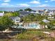 Community pool with sunbathers and lush landscaping, offering a relaxing oasis for residents with palm trees and seating at 921 Bradenville Ln, Winter Garden, FL 34787