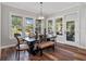 Elegant dining room with modern lighting, large windows, and stylish decor and seating at 921 Bradenville Ln, Winter Garden, FL 34787