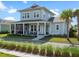 Charming two-story home featuring a screened porch, a welcoming front porch, and well-manicured landscaping at 921 Bradenville Ln, Winter Garden, FL 34787