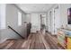 Hallway with wood floors, decorative furniture, and a staircase with wrought iron railings at 921 Bradenville Ln, Winter Garden, FL 34787