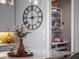 White marble countertop featuring a vase, large clock, and bar stocked with assorted beverages at 921 Bradenville Ln, Winter Garden, FL 34787