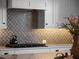 Kitchen with stainless steel range and backsplash, under cabinet lighting, light countertops and modern cabinets at 921 Bradenville Ln, Winter Garden, FL 34787