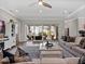 Bright living room featuring large sliding doors to the backyard and stylish, neutral decor at 921 Bradenville Ln, Winter Garden, FL 34787
