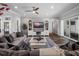 Comfortable living room featuring a decorative ceiling fan, a large TV, and sliding glass doors at 921 Bradenville Ln, Winter Garden, FL 34787