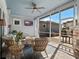 Inviting screened-in patio featuring comfortable seating, a TV, and stylish decor at 921 Bradenville Ln, Winter Garden, FL 34787