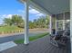 Relaxing screened-in porch with comfortable seating and a view of the landscaped neighborhood at 921 Bradenville Ln, Winter Garden, FL 34787