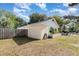 Backyard view of single-story home with a stucco exterior and a fenced yard at 1056 Pinder St, Deltona, FL 32725