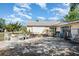 Inviting backyard featuring a stone firepit, cozy seating, and a charming swing at 1056 Pinder St, Deltona, FL 32725