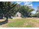 Single-story home with a stucco exterior, front patio, and mature shade trees at 1056 Pinder St, Deltona, FL 32725