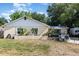 Cozy home with a stucco exterior, complemented by cacti landscaping and a seating area at 1056 Pinder St, Deltona, FL 32725