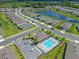 Aerial view highlighting a pool and community with manicured landscaping and water features at 1511 Lyonsdale Ln, Sanford, FL 32771
