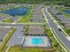 An aerial shot captures a community pool, clubhouse, and surrounding homes with ponds, and manicured lawns at 1511 Lyonsdale Ln, Sanford, FL 32771