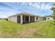 Back exterior view of the home showing the screened in patio and green backyard at 1511 Lyonsdale Ln, Sanford, FL 32771