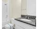 Clean bathroom features granite countertop, white cabinetry and new toilet at 1511 Lyonsdale Ln, Sanford, FL 32771