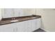 Bathroom features a double vanity, granite countertops, and undermount sinks at 1511 Lyonsdale Ln, Sanford, FL 32771