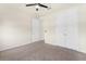 Carpeted bedroom features a ceiling fan, ample closet space, and neutral walls at 1511 Lyonsdale Ln, Sanford, FL 32771